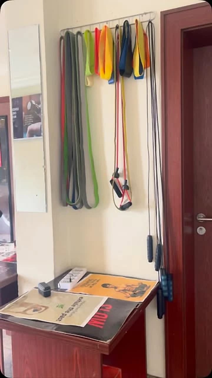 Resistance bands and TRX straps racked on the gym wall